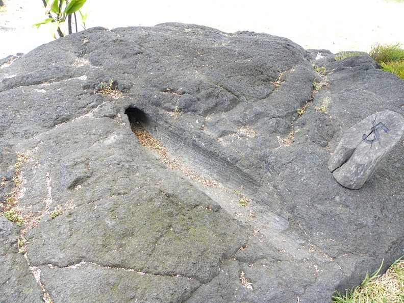 The lava flow knocked over a very wet tree, which caused the lava to solidify leaving an imprint of the tree behind.