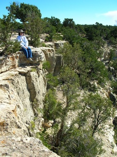 Tina, thinking it would be cool to dangle her legs into the Grand Canyon.